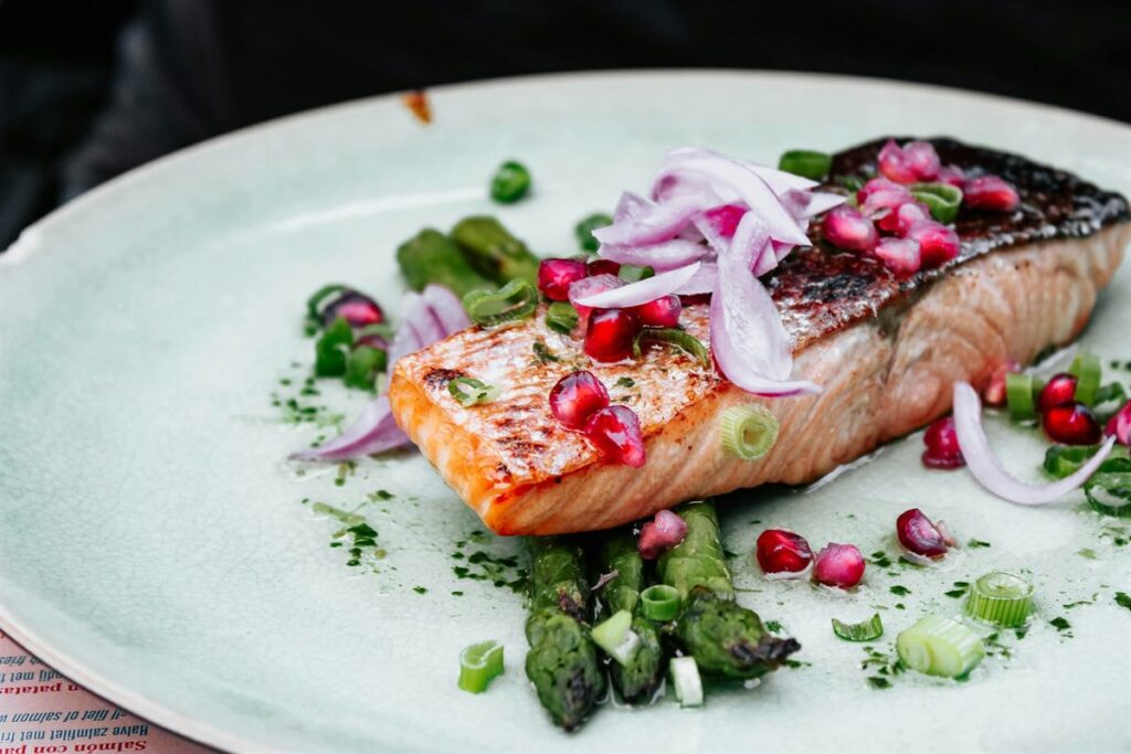 Salmon fillet plated with greens