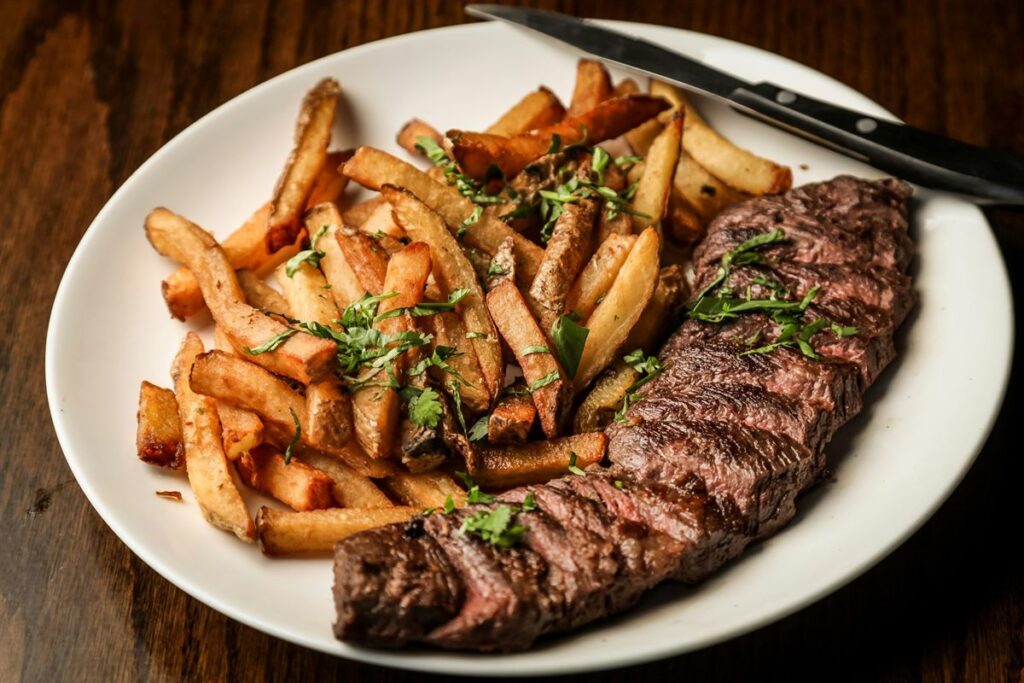Grilled steak served with hand cut fries